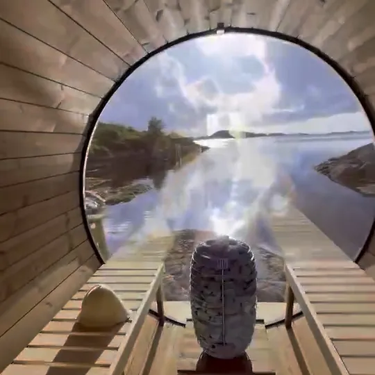 Inside a barrel sauna, looking out over the sea through the round window